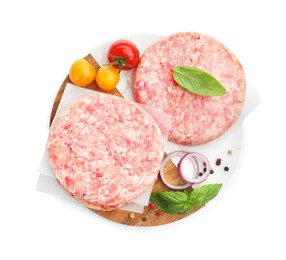 Photo of Fresh raw patties for burger, tomatoes and spices isolated on white, top view