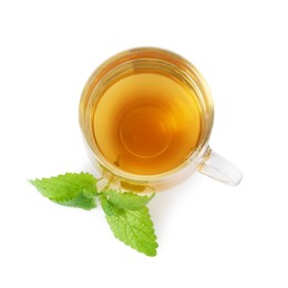 Photo of Aromatic lemon balm tea in glass cup and fresh leaves isolated on white, top view