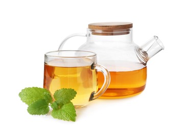 Photo of Aromatic lemon balm tea in glass cup, teapot and fresh leaves isolated on white