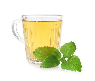Photo of Aromatic lemon balm tea in glass cup and fresh leaves isolated on white