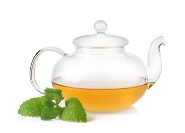 Photo of Aromatic lemon balm tea in glass teapot and fresh leaves isolated on white
