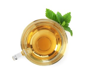 Photo of Aromatic lemon balm tea in glass cup and fresh leaves isolated on white, top view