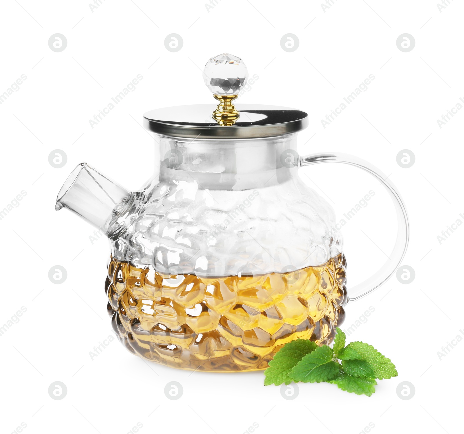 Aromatic lemon balm tea in glass teapot and fresh leaves isolated on white Photo of Aromatic lemon balm tea in glass teapot and fresh leaves isolated on white