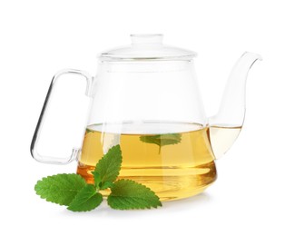 Photo of Aromatic lemon balm tea in glass teapot and fresh leaves isolated on white