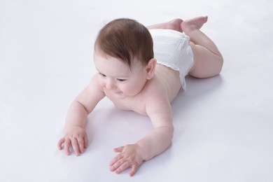 Photo of Cute little baby crawling on white background