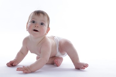 Photo of Cute little baby crawling on white background