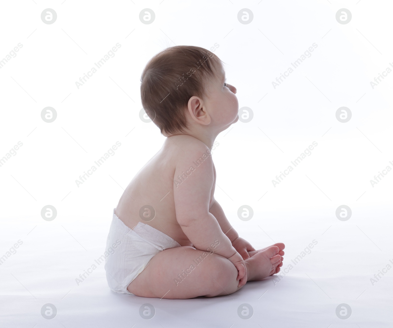 Cute little baby in diaper sitting on white background Photo of Cute little baby in diaper sitting on white background