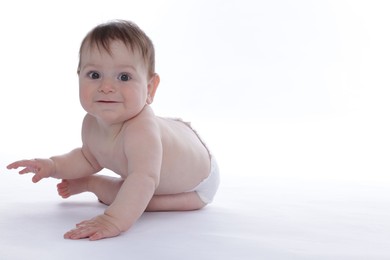 Photo of Cute little baby crawling on white background