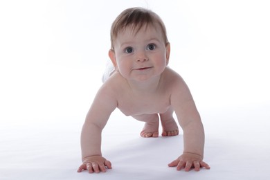 Photo of Cute little baby crawling on white background