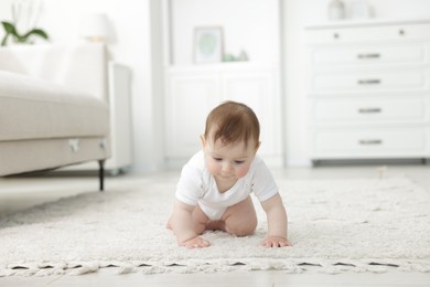 Photo of Cute little baby crawling on floor at home