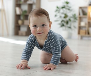 Photo of Cute little baby crawling on floor at home
