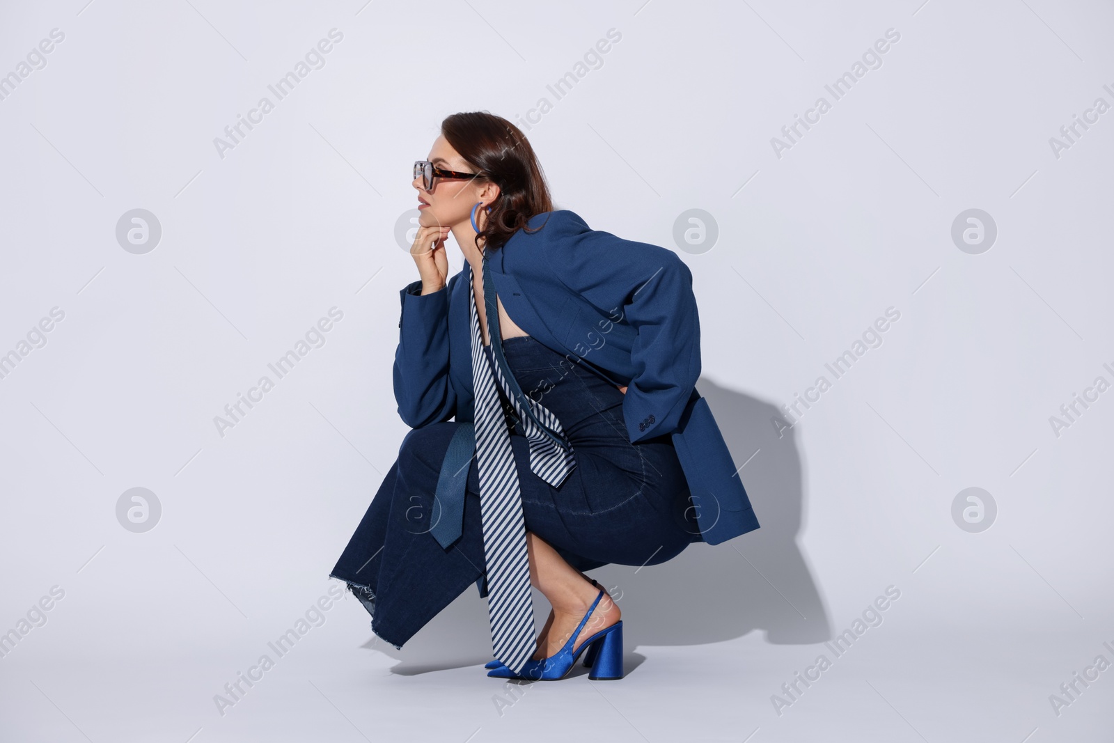 Young woman in stylish clothes on white background Photo of Young woman in stylish clothes on white background