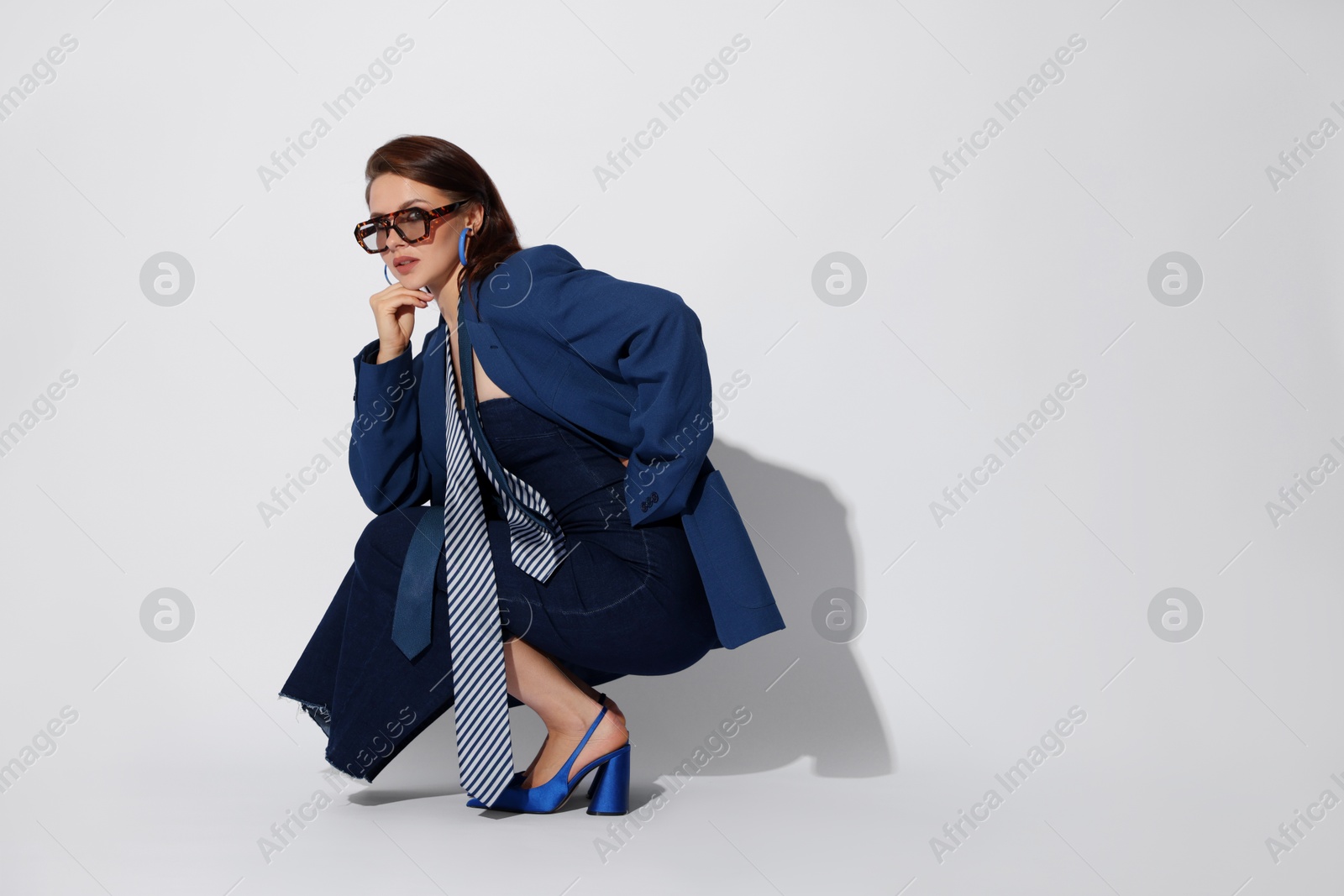 Young woman in stylish clothes on white background, space for text Photo of Young woman in stylish clothes on white background, space for text