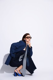 Photo of Young woman in stylish clothes on white background, space for text