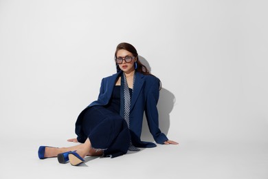 Photo of Young woman in stylish clothes on white background, space for text