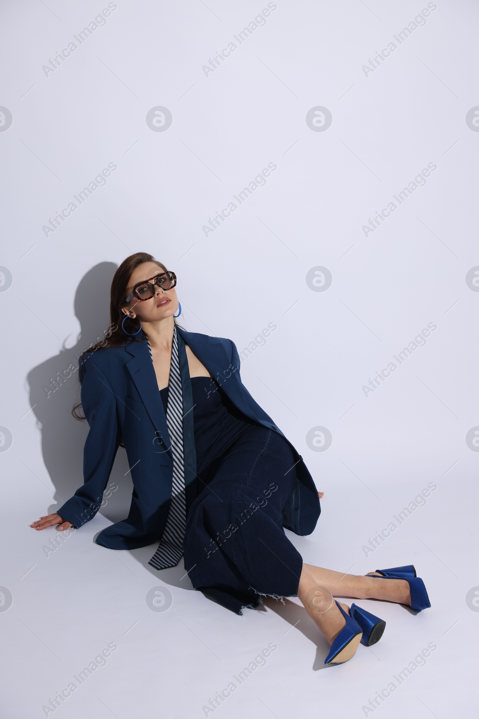 Young woman in stylish clothes on white background Photo of Young woman in stylish clothes on white background