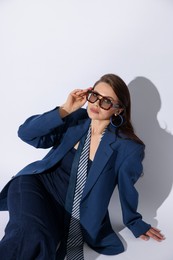 Photo of Young woman in stylish clothes on white background