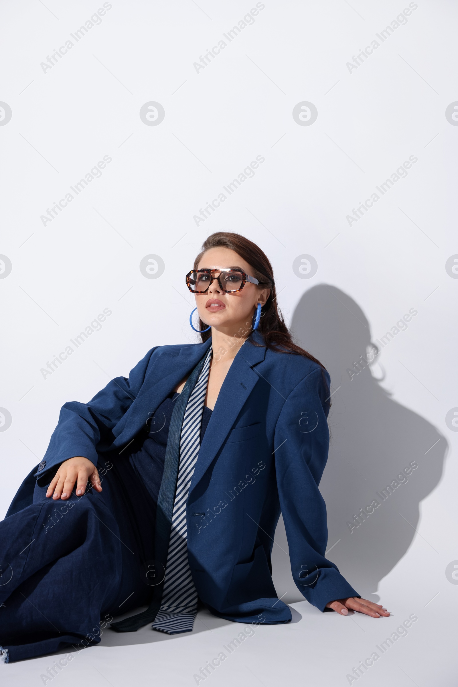 Young woman in stylish clothes on white background Photo of Young woman in stylish clothes on white background