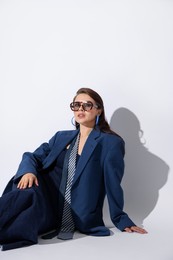 Photo of Young woman in stylish clothes on white background
