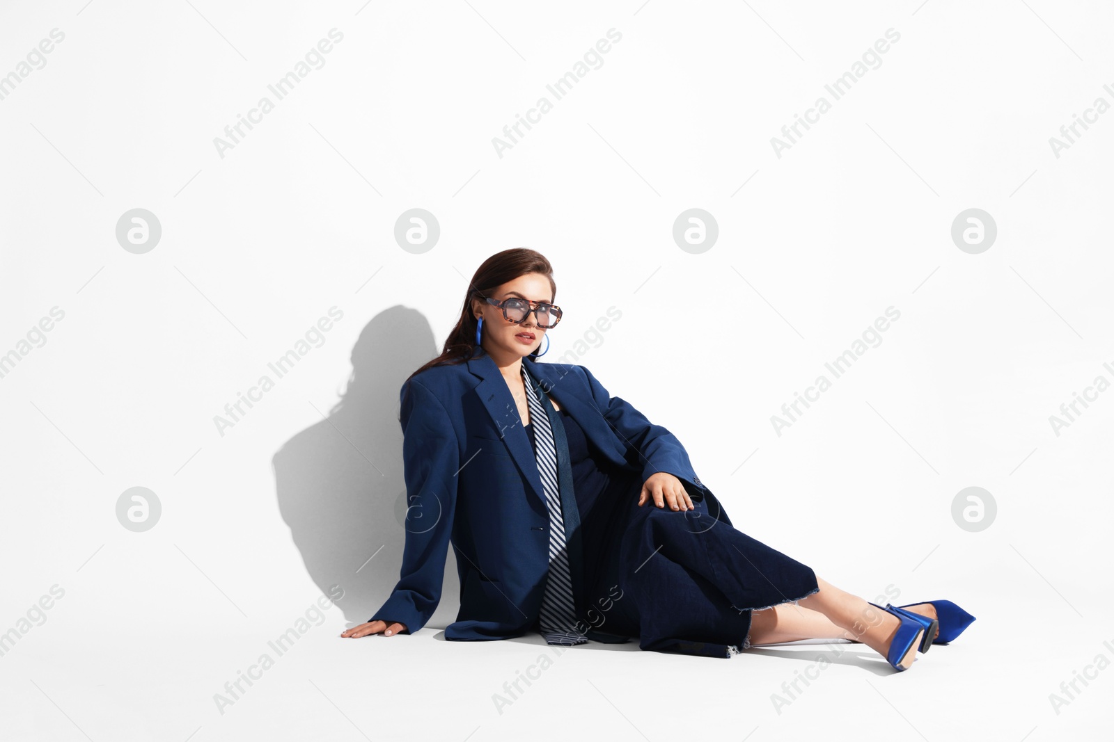 Young woman in stylish clothes on white background Photo of Young woman in stylish clothes on white background