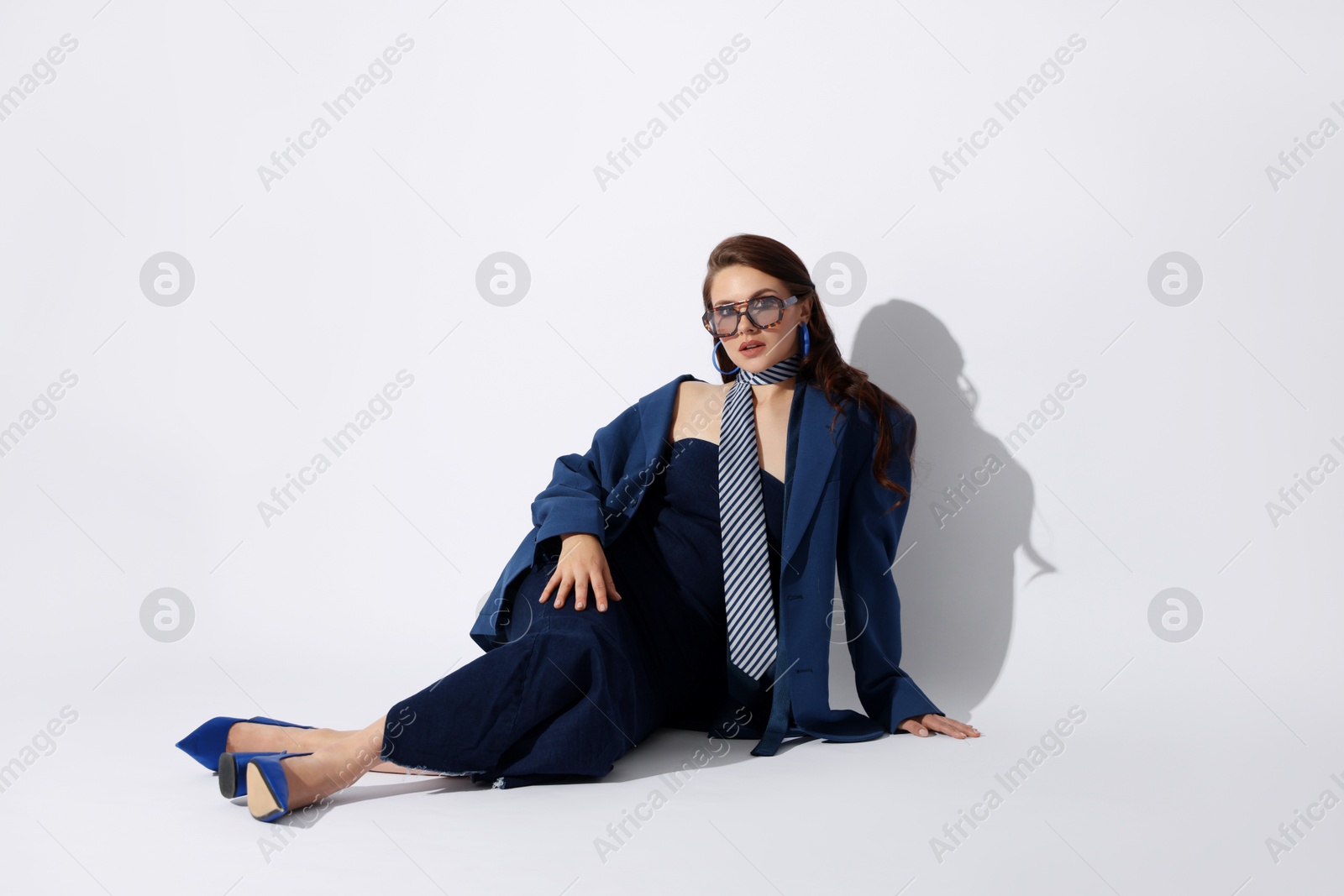 Young woman in stylish clothes on white background Photo of Young woman in stylish clothes on white background
