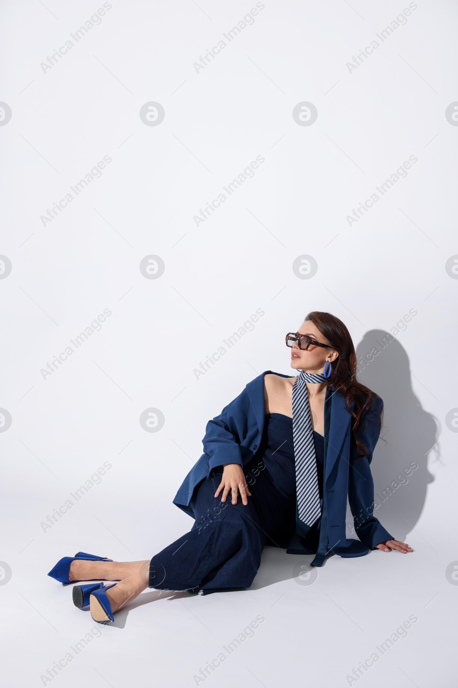 Young woman in stylish clothes on white background, space for text Photo of Young woman in stylish clothes on white background, space for text