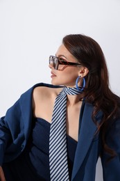 Photo of Young woman in stylish clothes on white background