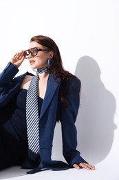 Photo of Young woman in stylish clothes on white background