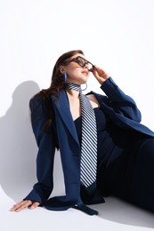 Photo of Young woman in stylish clothes on white background