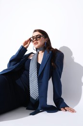 Photo of Young woman in stylish clothes on white background