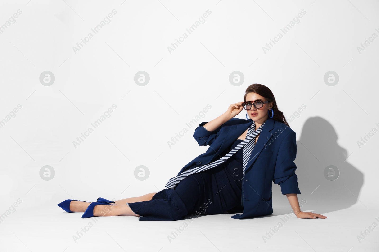 Young woman in stylish clothes on white background Photo of Young woman in stylish clothes on white background