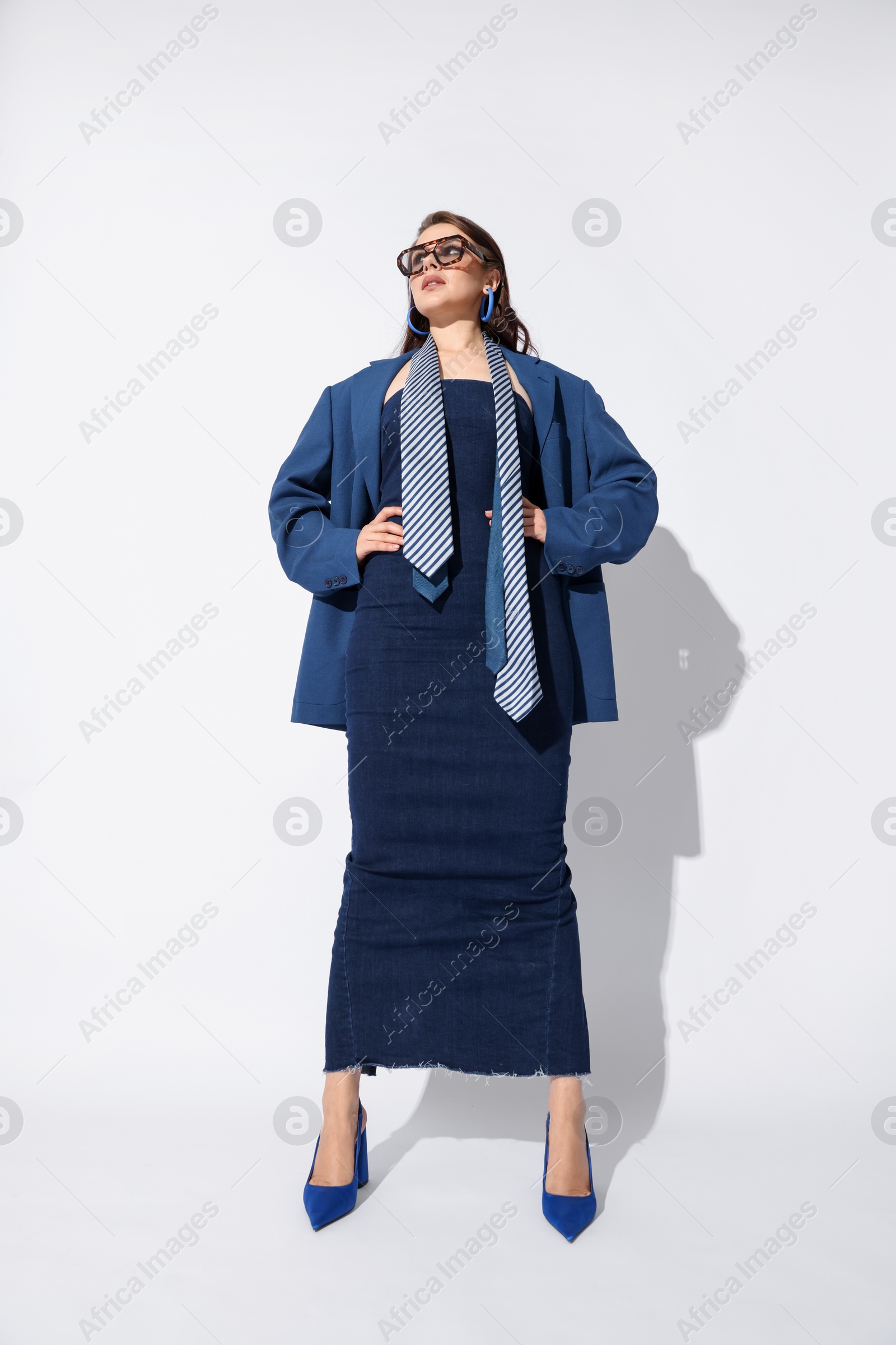 Young woman in stylish clothes on white background Photo of Young woman in stylish clothes on white background