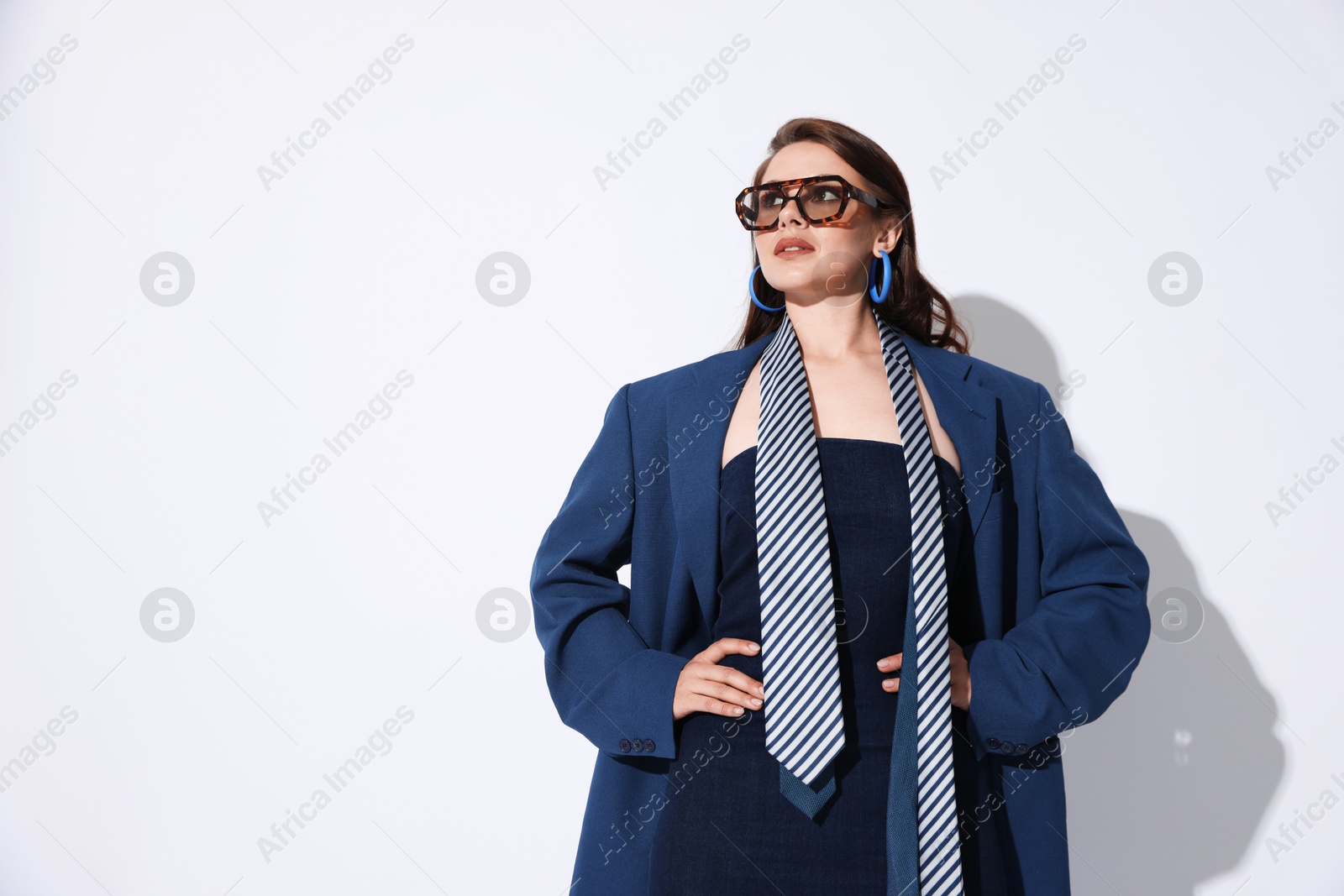Young woman in stylish clothes on white background, space for text Photo of Young woman in stylish clothes on white background, space for text