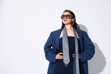 Photo of Young woman in stylish clothes on white background, space for text