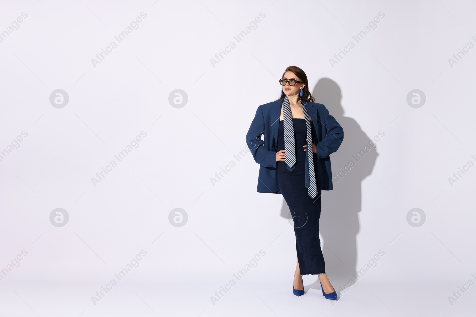 Young woman in stylish clothes on white background, space for text Photo of Young woman in stylish clothes on white background, space for text