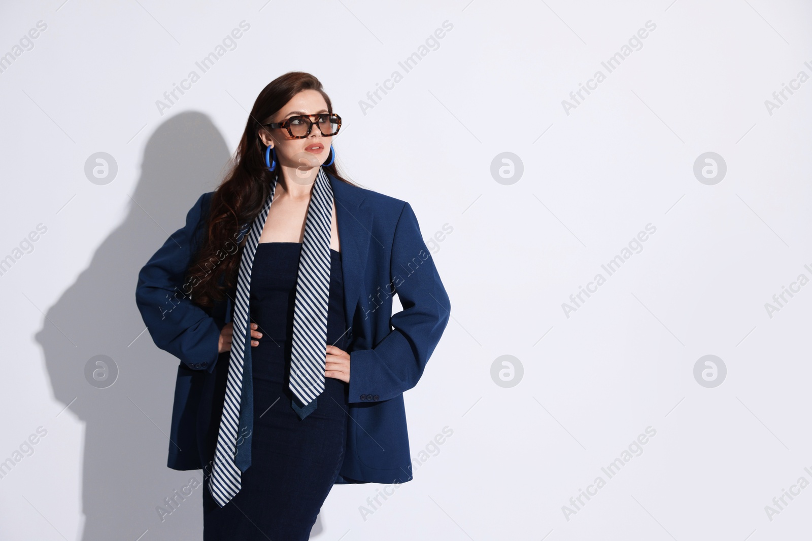 Young woman in stylish clothes on white background, space for text Photo of Young woman in stylish clothes on white background, space for text