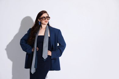 Photo of Young woman in stylish clothes on white background, space for text