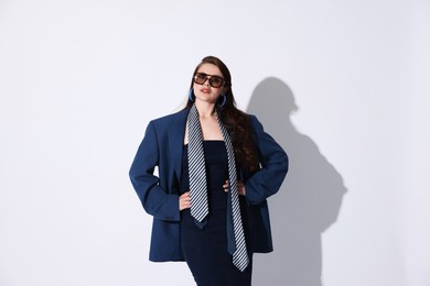 Photo of Young woman in stylish clothes on white background