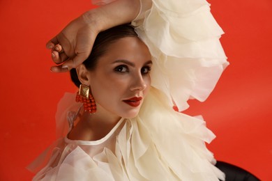 Photo of Young woman in stylish clothes on red background