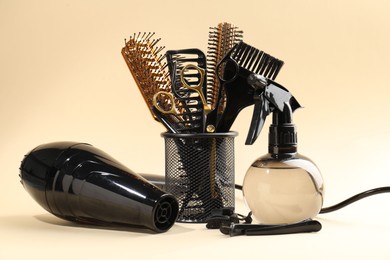 Photo of Many different hairdresser's tools on beige background