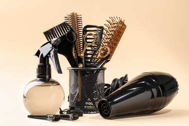 Photo of Many different hairdresser's tools on beige background