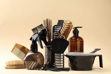 Photo of Many different hairdresser's tools on beige background