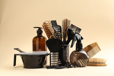 Photo of Many different hairdresser's tools on beige background