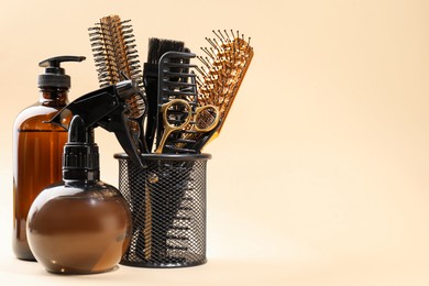 Photo of Different hairdresser's tools on beige background, space for text