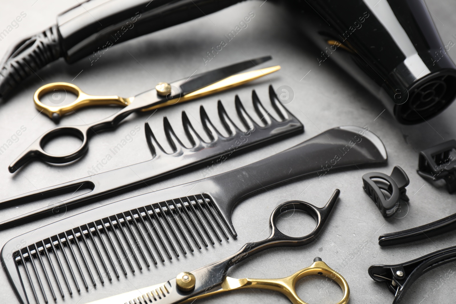 Different hairdresser's tools on grey table, closeup Photo of Different hairdresser's tools on grey table, closeup
