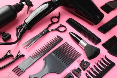 Photo of Different hairdresser's tools on pink background, above view