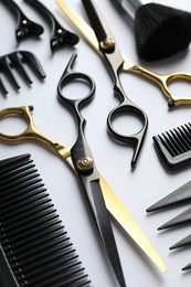 Photo of Different hairdresser's tools on white background, closeup