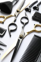 Photo of Different hairdresser's tools on white background, closeup