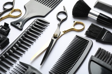 Photo of Different hairdresser's tools on white background, closeup
