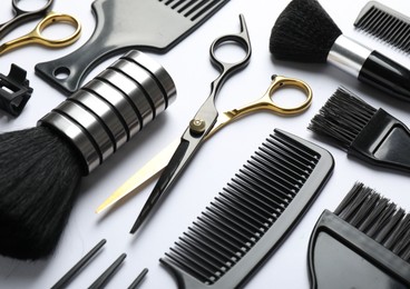 Photo of Different hairdresser's tools on white background, closeup